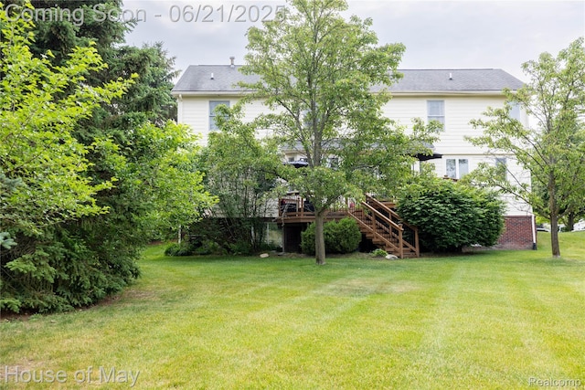 1768 Carriage Hl, Commerce Twp, MI 48382 - view of grassy yard with stairs and a deck