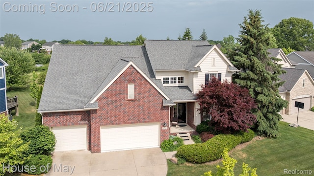 1768 Carriage Hl, Commerce Twp, MI 48382 - traditional home with brick siding, driveway, roof with shingles, and a front lawn