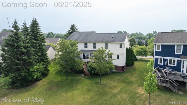 1768 Carriage Hl, Commerce Twp, MI 48382 - rear view of house featuring stairway, a wooden deck, and a lawn