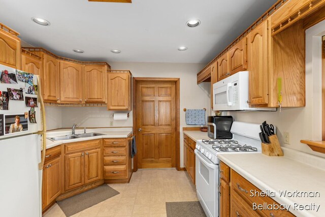 1725 Ottawa Trl, Hastings, MI 49058 - kitchen featuring white appliances, light countertops, recessed lighting, and brown cabinetry