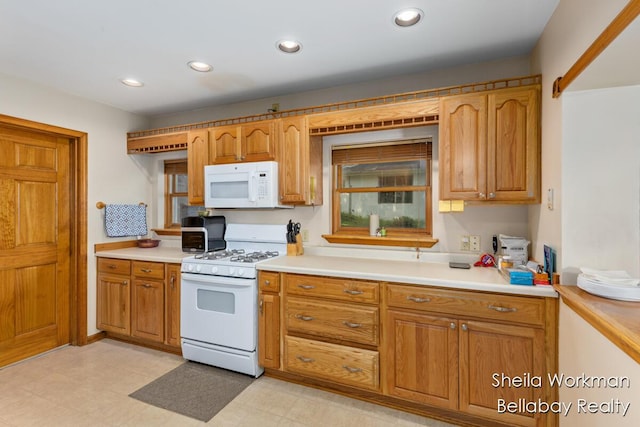 1725 Ottawa Trl, Hastings, MI 49058 - kitchen featuring white appliances, light countertops, brown cabinets, and recessed lighting