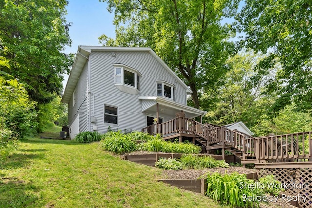 1725 Ottawa Trl, Hastings, MI 49058 - rear view of property featuring a lawn, a wooden deck, and stairway