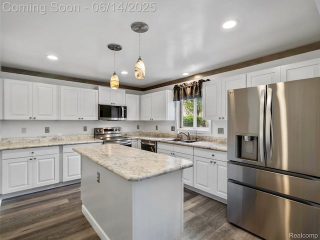 4960 Paula Ave, Clarkston, MI 48346 - kitchen featuring appliances with stainless steel finishes, white cabinets, a kitchen island, pendant lighting, and recessed lighting