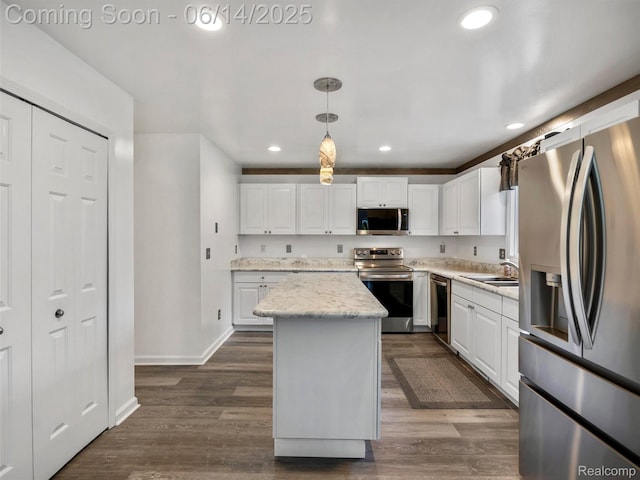4960 Paula Ave, Clarkston, MI 48346 - kitchen featuring appliances with stainless steel finishes, a kitchen island, recessed lighting, white cabinets, and decorative light fixtures