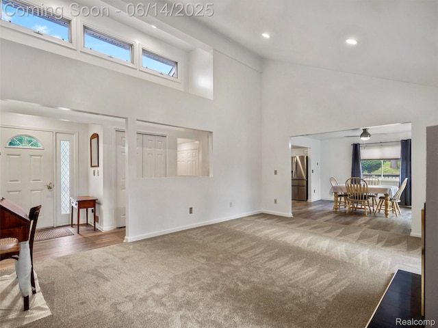 4960 Paula Ave, Clarkston, MI 48346 - carpeted living area with high vaulted ceiling, a ceiling fan, and recessed lighting