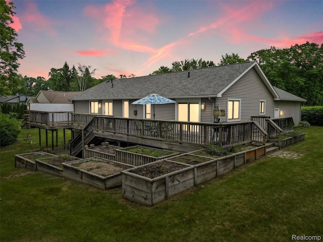 4960 Paula Ave, Clarkston, MI 48346 - rear view of house featuring a garden, a wooden deck, a shingled roof, and a lawn