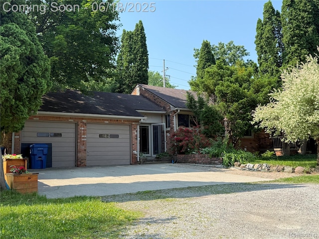 6715 Elizabeth Lake Rd, Waterford, MI 48327 - view of front of house featuring concrete driveway, brick siding, and an attached garage