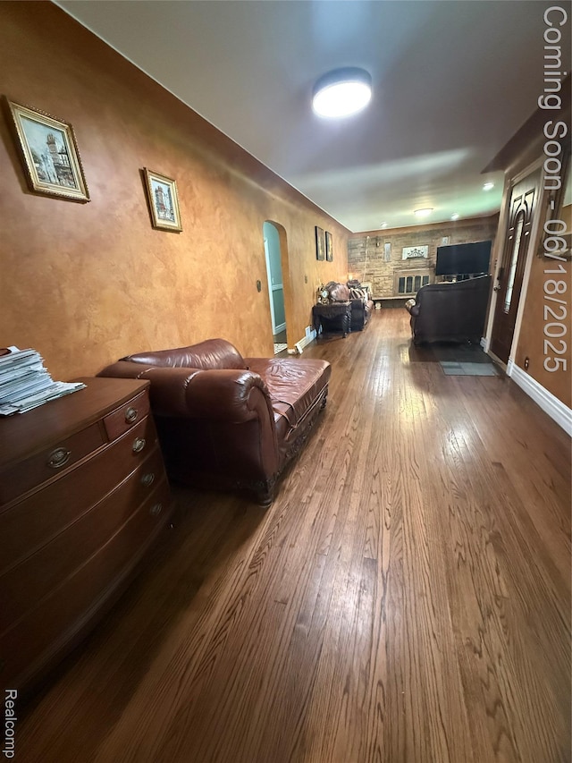 6715 Elizabeth Lake Rd, Waterford, MI 48327 - living area featuring arched walkways and dark wood-style floors