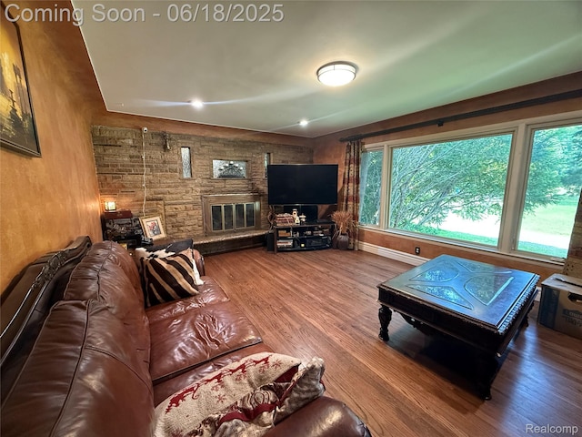 6715 Elizabeth Lake Rd, Waterford, MI 48327 - living room featuring a stone fireplace and wood finished floors
