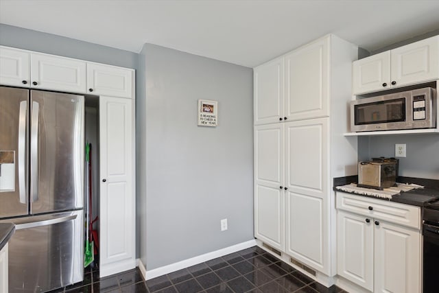 14747 A Dr N, Marshall, MI 49068 - kitchen with stainless steel appliances, white cabinetry, and dark tile patterned flooring