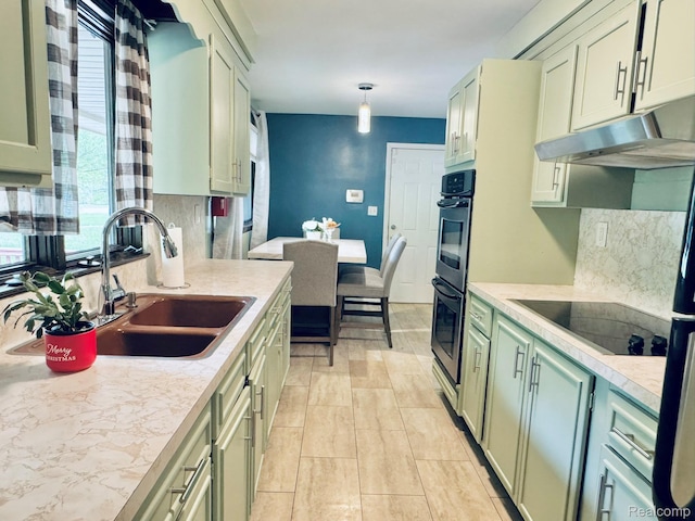 24230 Berg Rd, Commerce Twp, MI 48033 - kitchen with green cabinetry, black electric stovetop, under cabinet range hood, backsplash, and light countertops
