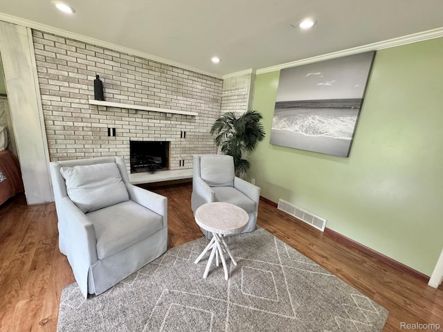 24230 Berg Rd, Commerce Twp, MI 48033 - sitting room featuring a fireplace, wood finished floors, crown molding, and recessed lighting