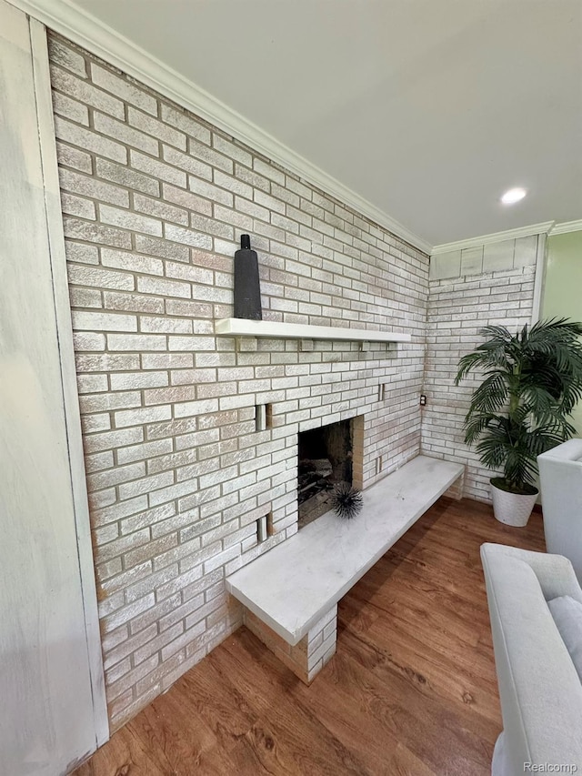 24230 Berg Rd, Commerce Twp, MI 48033 - living area featuring ornamental molding, a brick fireplace, wood finished floors, and brick wall