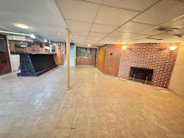 24230 Berg Rd, Commerce Twp, MI 48033 - unfurnished living room with a fireplace, wooden walls, and a paneled ceiling