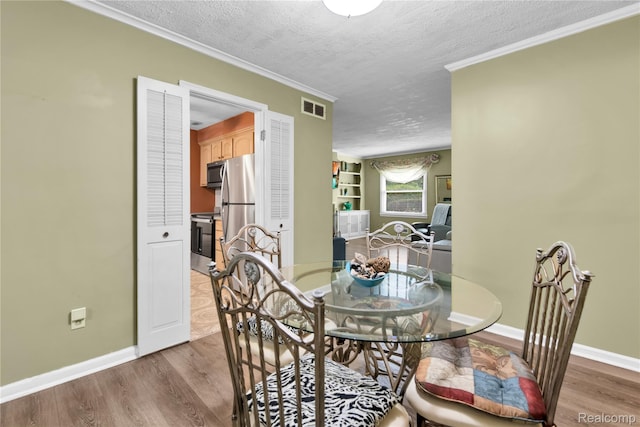 24710 Lathrup Blvd, Southfield, MI 48075 - dining area with a textured ceiling, wood finished floors, and ornamental molding