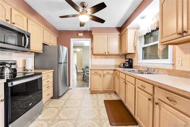 24710 Lathrup Blvd, Southfield, MI 48075 - kitchen with appliances with stainless steel finishes, light brown cabinetry, light countertops, ceiling fan, and backsplash
