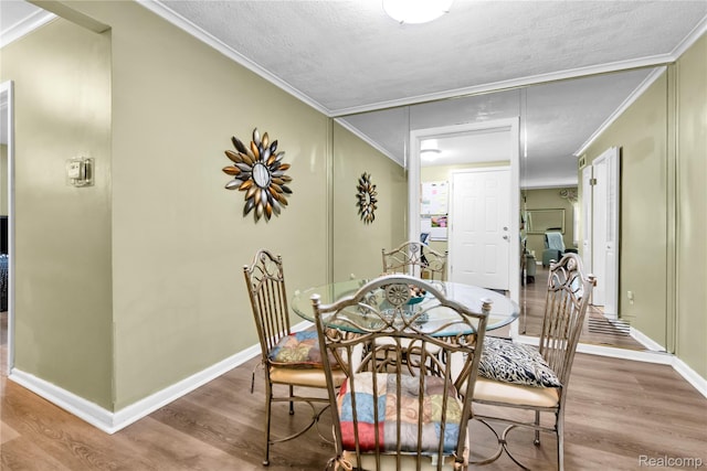 24710 Lathrup Blvd, Southfield, MI 48075 - dining room featuring wood finished floors, crown molding, and a textured ceiling