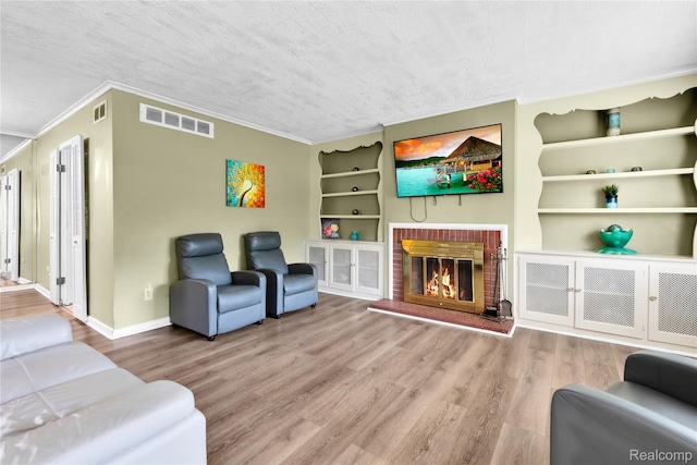 24710 Lathrup Blvd, Southfield, MI 48075 - living room with built in shelves, crown molding, wood finished floors, and a brick fireplace
