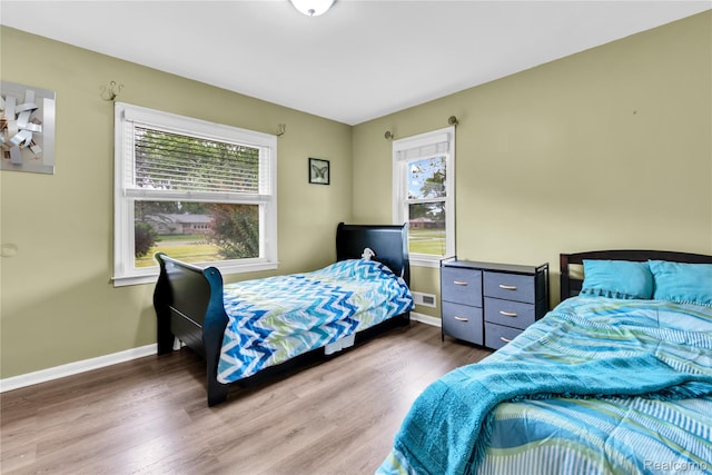 24710 Lathrup Blvd, Southfield, MI 48075 - bedroom with multiple windows and wood finished floors