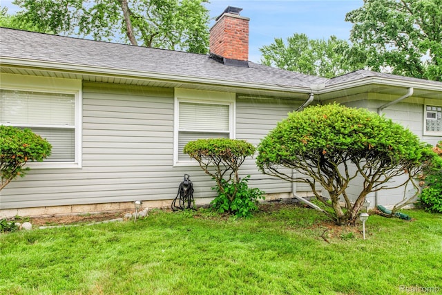 24710 Lathrup Blvd, Southfield, MI 48075 - view of property exterior with a lawn, a chimney, and a shingled roof