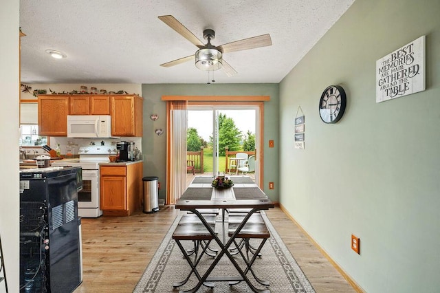 66291 M-62, Edwardsburg, MI 49112 - kitchen with white appliances, light wood-style flooring, ceiling fan, plenty of natural light, and a textured ceiling