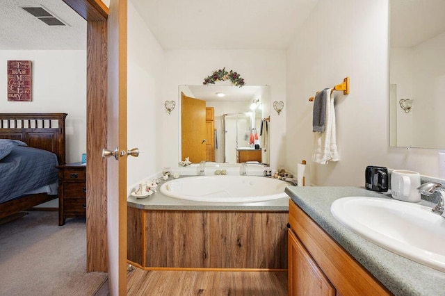 66291 M-62, Edwardsburg, MI 49112 - full bath featuring a stall shower, a garden tub, vanity, and connected bathroom