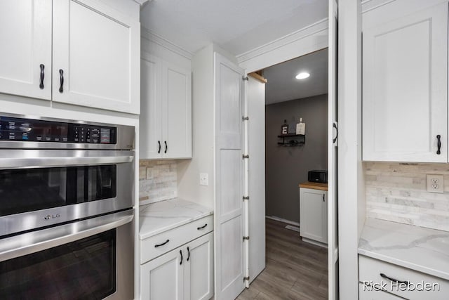 1153 S Edgar Rd, Mason, MI 48854 - kitchen with stainless steel double oven, tasteful backsplash, white cabinets, wood finished floors, and recessed lighting