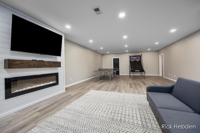1153 S Edgar Rd, Mason, MI 48854 - living room featuring wood finished floors, a fireplace, and recessed lighting