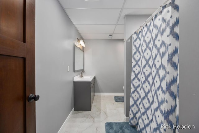 1153 S Edgar Rd, Mason, MI 48854 - full bathroom with a paneled ceiling, vanity, marble finish floors, and a shower with shower curtain