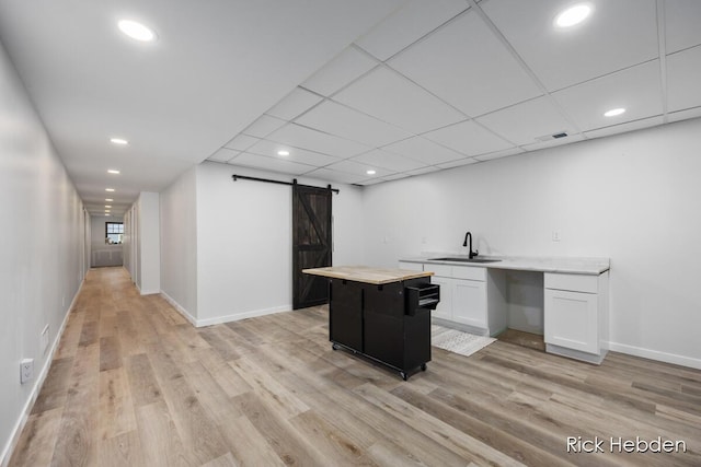 1153 S Edgar Rd, Mason, MI 48854 - unfurnished office featuring a barn door, light wood-style flooring, and recessed lighting