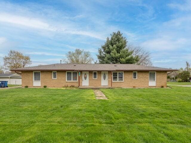 1314 Magnolia St, Kalamazoo, MI 49048 - view of front of house with a front lawn and brick siding