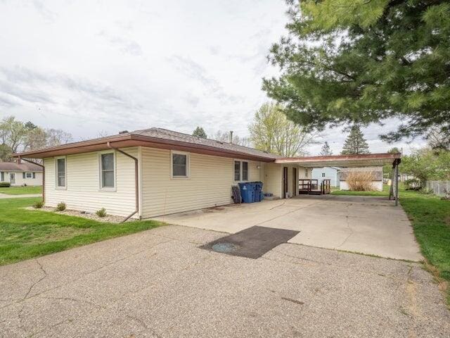 1314 Magnolia St, Kalamazoo, MI 49048 - view of property exterior with asphalt driveway and a carport