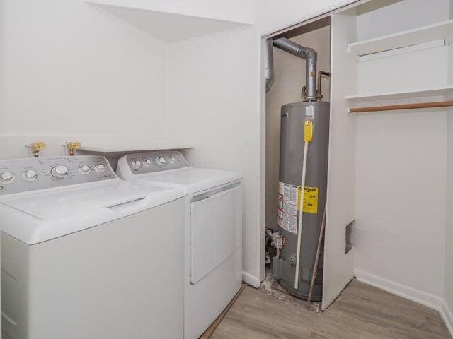 1314 Magnolia St, Kalamazoo, MI 49048 - laundry area featuring gas water heater, washing machine and clothes dryer, and light wood-style floors