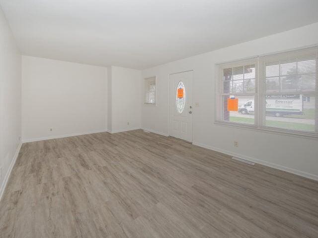 1314 Magnolia St, Kalamazoo, MI 49048 - unfurnished living room featuring light wood-type flooring and baseboards