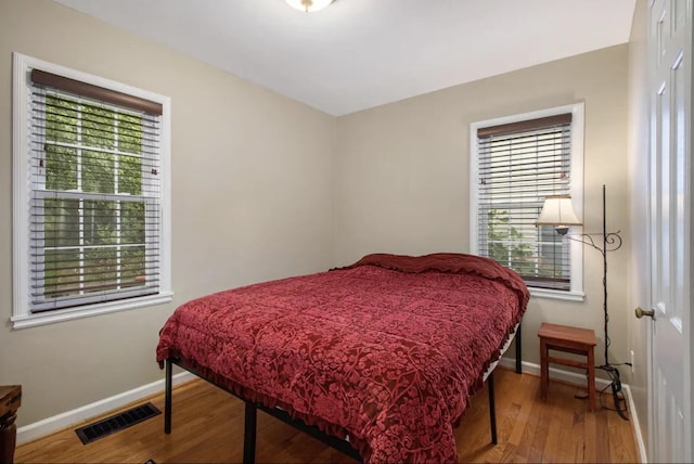 1307 Edgewood Ave, Ann Arbor, MI 48103 - bedroom featuring multiple windows and wood finished floors