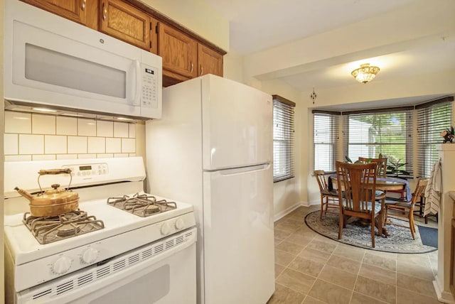 1307 Edgewood Ave, Ann Arbor, MI 48103 - kitchen with white appliances, brown cabinetry, and decorative backsplash