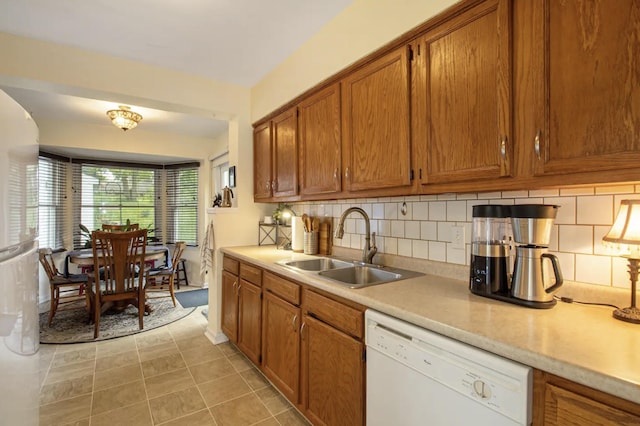 1307 Edgewood Ave, Ann Arbor, MI 48103 - kitchen with white appliances, brown cabinetry, light countertops, and tasteful backsplash