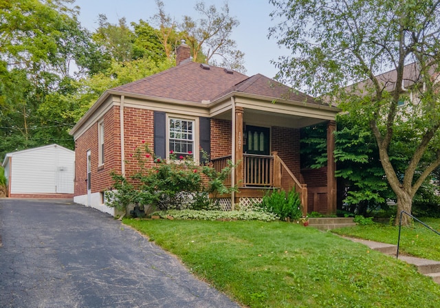 1307 Edgewood Ave, Ann Arbor, MI 48103 - view of front facade featuring brick siding, a porch, and a front yard