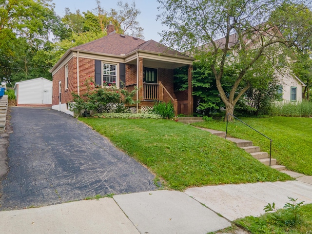 1307 Edgewood Ave, Ann Arbor, MI 48103 - view of front of property featuring brick siding, a front lawn, covered porch, an outdoor structure, and a chimney