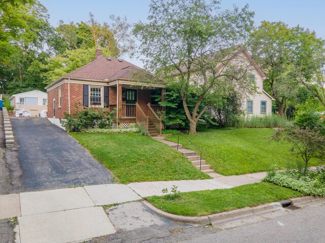 1307 Edgewood Ave, Ann Arbor, MI 48103 - view of front of property featuring brick siding, an outbuilding, a front yard, covered porch, and stairs