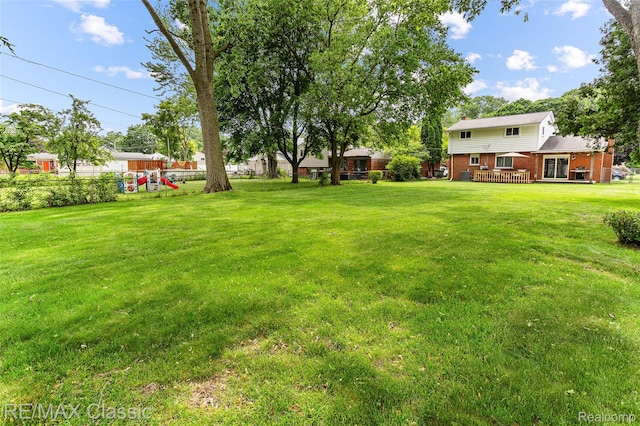 1915 Treadwell St, Westland, MI 48186 - view of grassy yard featuring a playground and a wooden deck