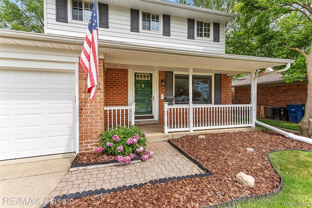 1915 Treadwell St, Westland, MI 48186 - view of front of property featuring covered porch, brick siding, and concrete driveway