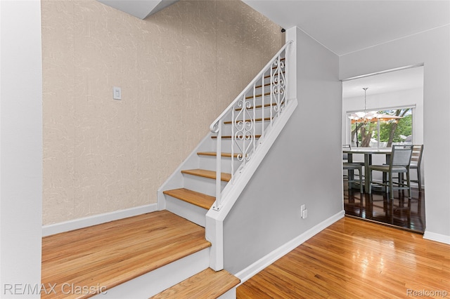 1915 Treadwell St, Westland, MI 48186 - stairs with wood finished floors and a chandelier