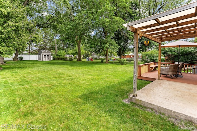 1915 Treadwell St, Westland, MI 48186 - fenced backyard with a wooden deck, a shed, and view of scattered trees