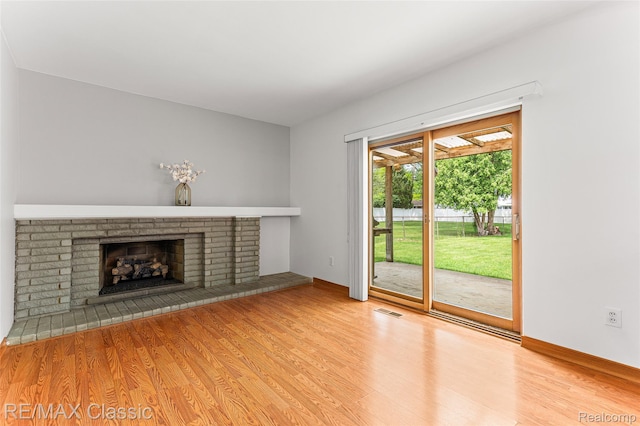 1915 Treadwell St, Westland, MI 48186 - unfurnished living room with wood finished floors and a brick fireplace