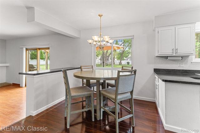 1915 Treadwell St, Westland, MI 48186 - dining area featuring dark wood-style floors and a chandelier