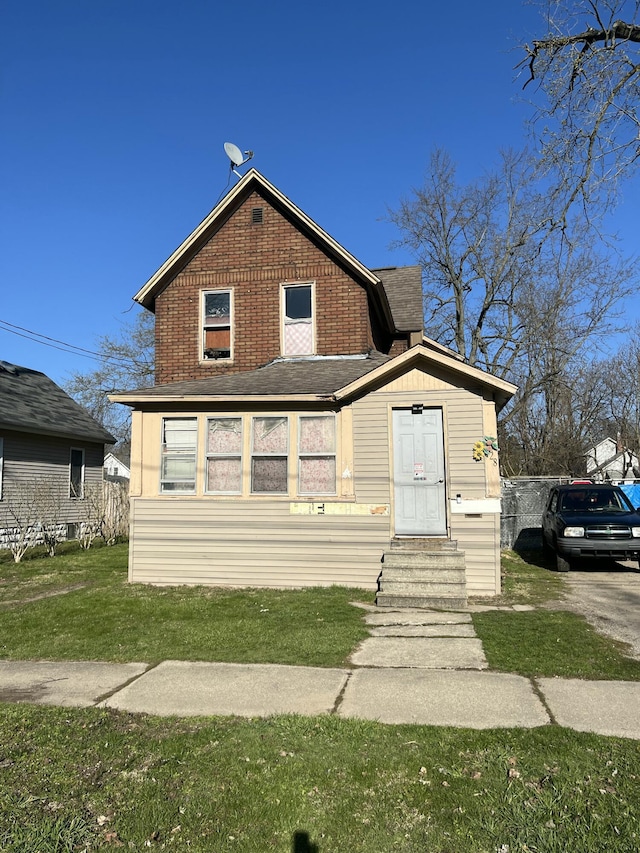 928 Trimble Ave, Kalamazoo, MI 49048 - view of front facade with entry steps, a front yard, and brick siding