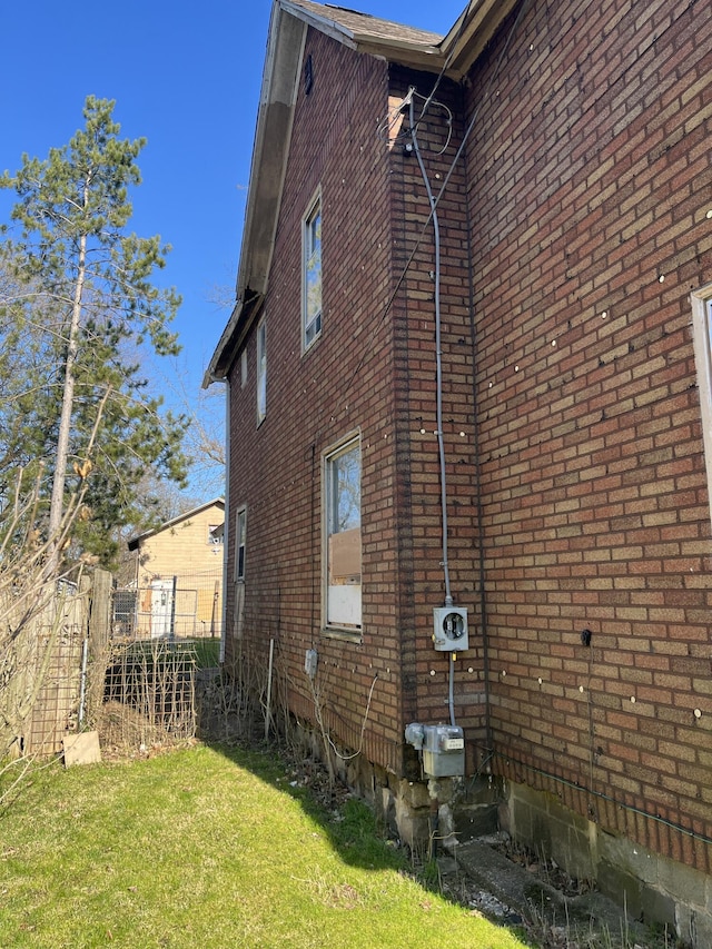 928 Trimble Ave, Kalamazoo, MI 49048 - view of side of home with brick siding and a lawn