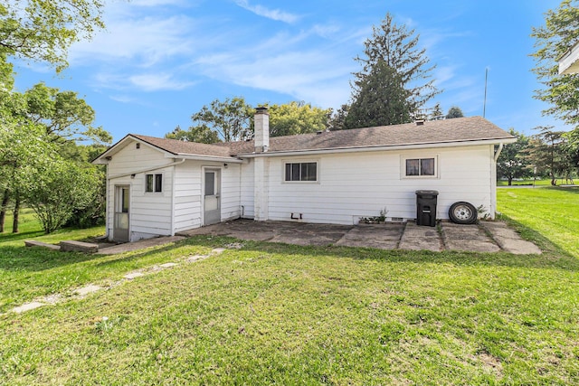 5468 S Custer Rd, Custer, MI 49405 - rear view of house with a patio, a lawn, and a chimney