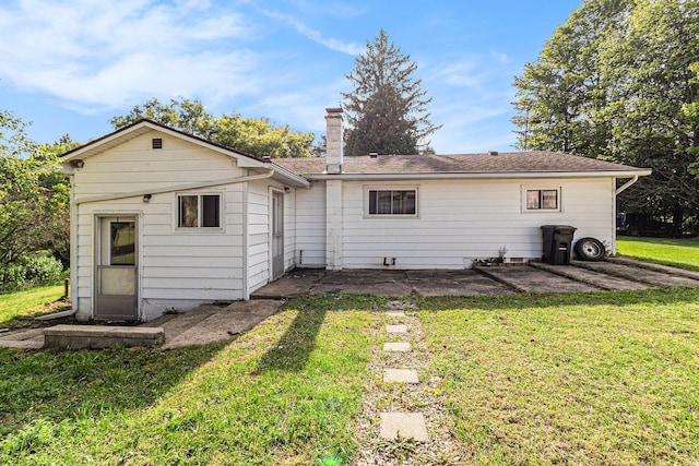 5468 S Custer Rd, Custer, MI 49405 - rear view of house featuring a yard and a chimney